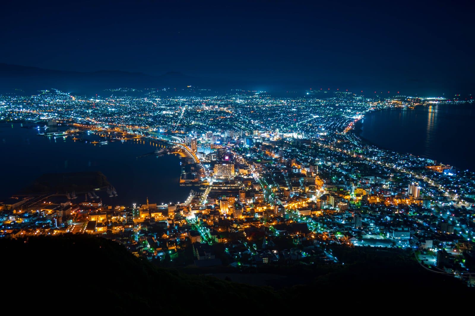 The lights of Hakodate city between two bays, seen at night from above