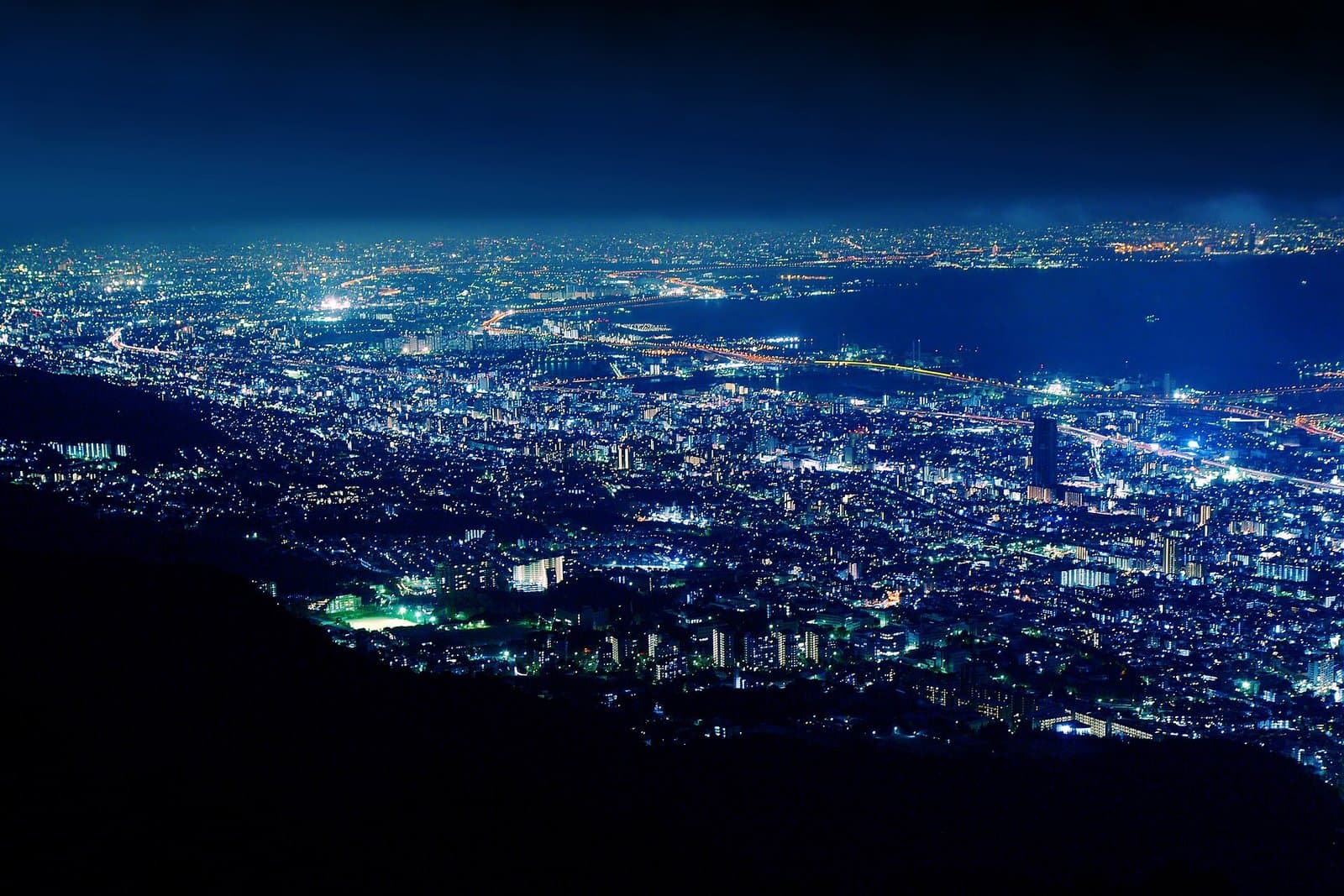 The lights of Kobe spreading to the bay at night, seen from the mountain